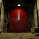 A large red door at the end of a stone hallway from Call of Duty's new fast-travel system.